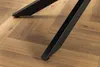 Close-up of black metal table legs on a wooden floor. Produktbild-Vorschau