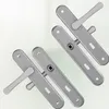 Two pairs of door handles with escutcheons on a light background. Anteprima dell’immagine prodotto