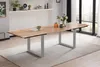 A dining table in a modern room with large windows. Produktbild-Vorschau