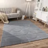 A living room scene with a sofa, rug, and shelving unit. Anteprima dell’immagine prodotto