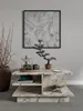 A modern living room setting with a marble coffee table, artwork, and decorative items. Náhľad obrázku produktu