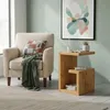 A cozy living room scene with a chair, side table, and artwork. Produktbild-Vorschau