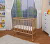A nursery room with a wooden crib, shelves with toys, and curtains. Produktbild-Vorschau