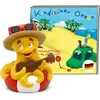 A toy octopus playing a guitar on a life preserver, with a book cover in the background depicting a beach scene with a car and children. Produktbild-Vorschau