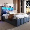 A bedroom scene with a blue upholstered bed as the main focus, featuring integrated LED lighting in the headboard. Produktbild-Vorschau
