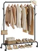 A clothing rack with clothes, shoes, and boxes on it, set against a white background. Náhled obrázku produktu
