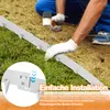 A person installing a metal garden edge in the grass. Produktbild-Vorschau
