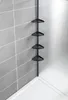 A black telescopic corner shelf unit with four triangular shelves is shown in a shower stall. Náhled obrázku produktu