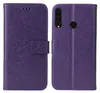 A purple flip phone case with a floral and butterfly embossed design is shown. Produktbild-Vorschau