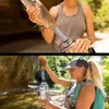 Two women are shown filtering water using a LifeStraw Peak Series Personal Filter Straw Solo in outdoor settings. Podgląd zdjęcia produktu