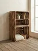 Wooden crates stacked to form a shelving unit, placed against a wall near a window. Náhled obrázku produktu