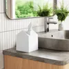 A white house-shaped tissue box sits on a bathroom counter next to a sink and faucet. Anteprima dell’immagine prodotto