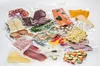 A variety of vacuum-sealed food products are spread out on a white surface. Podgląd zdjęcia produktu