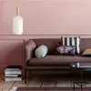 A living room scene with a sofa, pillows, a side table, and a hanging lamp. Náhľad obrázku produktu