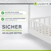A white wooden bed frame with a railing, presented with marketing text highlighting safety features. Náhled obrázku produktu