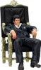 A figurine of Tony Montana from Scarface sitting on a throne. Náhľad obrázku produktu