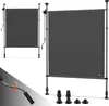 Two gray retractable awnings are shown against a white background. One is smaller and to the left, the other is larger and to the right. A crank handle and some accessory feet are shown in the bottom left and bottom right corners respectively. Anteprima dell’immagine prodotto