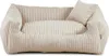 A beige corduroy dog bed with a small pillow.
