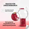 A red gumball machine with a close-up inset showing the dispensing mechanism, set against a gradient pink and white background with text overlays. Náhled obrázku produktu