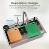 A stainless steel sink with accessories, demonstrating a dual-track design for moving items like cutting boards. Produktbild-Vorschau