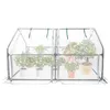 A white greenhouse with plants inside, set against a white background. Voir les images du produit