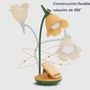 A desk lamp shaped like a flower, with multiple ghosted images showing its flexibility and rotation. Produktbild-Vorschau