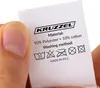A hand holding a clothing care label with washing instructions. Anteprima dell’immagine prodotto