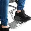 A close-up view of a person's feet and legs wearing jeans and black sneakers, resting on a silver footrest of a chair or mobility device. Náhľad obrázku produktu