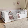 A white bed with pink and gray bedding in a room with pale yellow walls and a pink decorative border. Produktbild-Vorschau