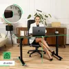 A woman is working at a height-adjustable desk in a home office setting. Produktbild-Vorschau