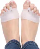 A close-up view of a person's feet wearing toe separators. Podgląd zdjęcia produktu