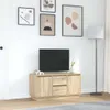 A modern living room with a TV stand, television, and decorative items. Náhled obrázku produktu