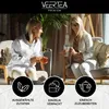 Two women are sitting and enjoying tea, with icons and text below highlighting product features. Produktbild-Vorschau
