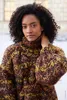 A woman wearing a chunky knit sweater. Produktbild-Vorschau