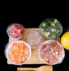 A collection of food items, including broccoli, meat, and sliced carrots, are arranged on a wooden board and covered in plastic wrap. Anteprima dell’immagine prodotto