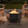 A hexagonal fire pit with a fire burning in it, placed on a patio with chairs and drinks nearby. Náhled obrázku produktu