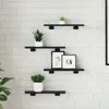 Four black wooden shelves mounted on a white brick wall, decorated with two potted plants and two framed pictures. Produktbild-Vorschau