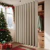 A Christmas-themed room with a decorated tree, gifts, and a large curtain room divider. Produktbild-Vorschau