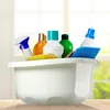 A collection of cleaning supplies in a white basin, set against a blurred background of a window with greenery outside. Produktbild-Vorschau