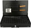 A black portable grill with accessories inside, shown open. Voir les images du produit