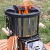 A rocket stove is burning outdoors on a wooden table. Produktbild-Vorschau