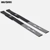 Two black lifting straps with white grip patterns and logos, laid out diagonally on a white background. Produktbild-Vorschau