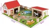 A wooden toy farm set with various animals and buildings, set on a green mat with a pond. Anteprima dell’immagine prodotto