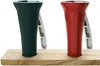 Two nutcrackers, one red and one black, are placed on a wooden surface against a white background. Podgląd zdjęcia produktu