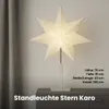 A white star-shaped lamp on a gray cabinet. Podgląd zdjęcia produktu