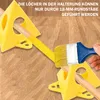 Painting pyramids used to support objects while painting, with a paintbrush in use. Produktbild-Vorschau