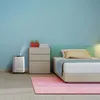 A bedroom scene with a humidifier next to a nightstand and bed. Produktbild-Vorschau
