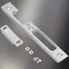 A set of metal door hardware components, including a strike plate, a latch, and screws, arranged on a gradient background. Produktbild-Vorschau