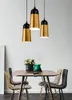 A dining table with chairs and pendant lights above. Produktbild-Vorschau