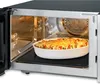 A microwave oven with a dish of food inside. Produktbild-Vorschau